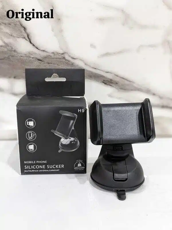 Universal mobile phone holder mounted on a car dashboard.